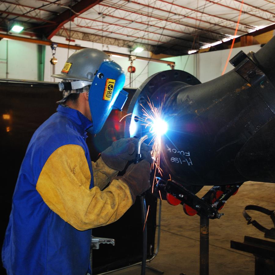 Employee welding a pipe
