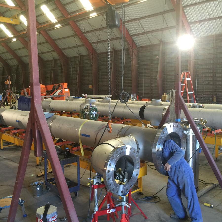 Stainless steel piping being assembled in warehouse
